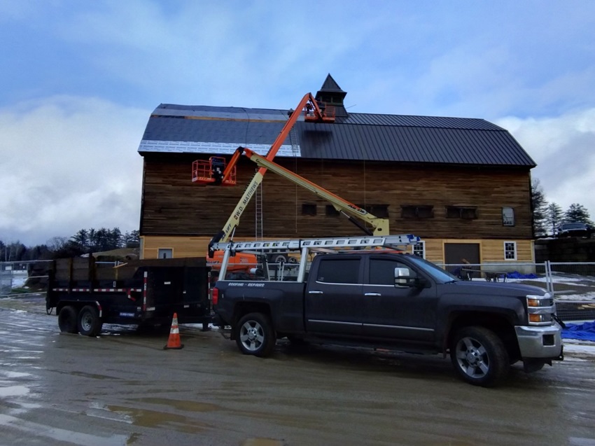 A Truck Parked Next To A Rustic Barn