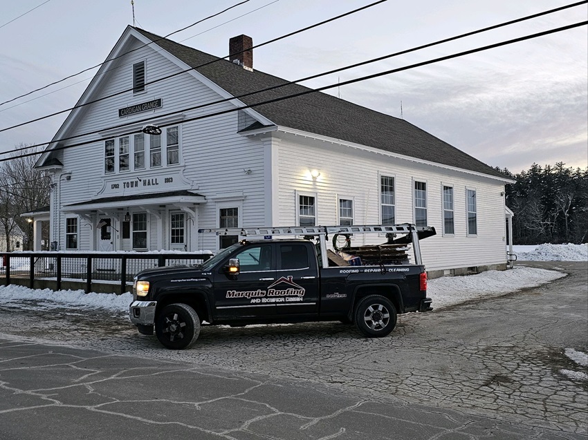 A Truck Parked In Front Of A White House